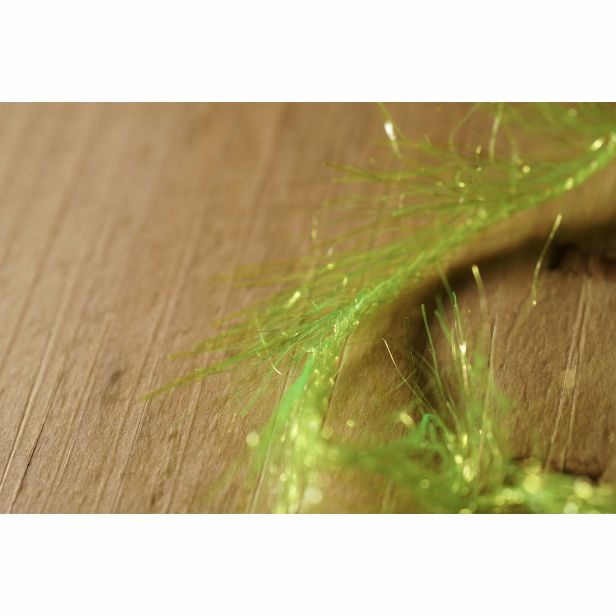 Close-up of translucent chartreuse chenille fibers and metallic flash