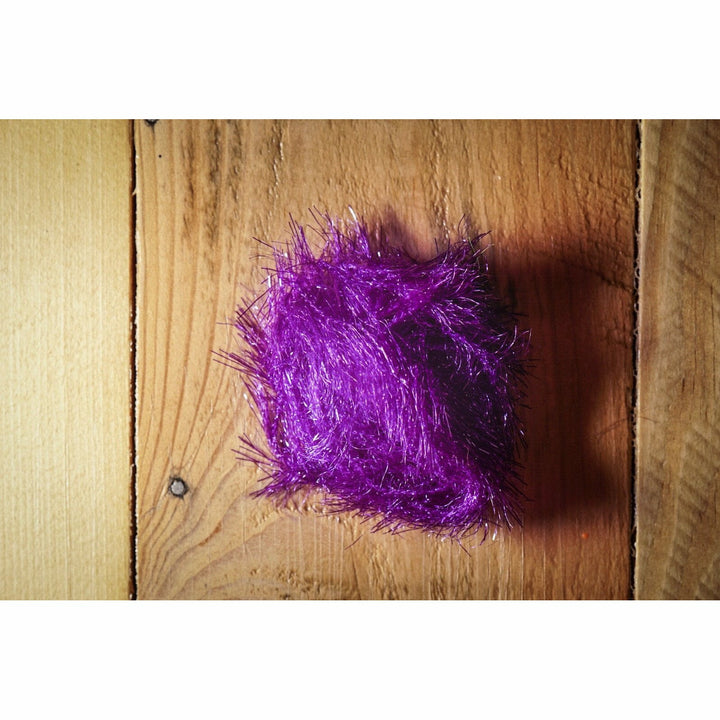 Purple Krystal Hackle fly tying material bundle on wood