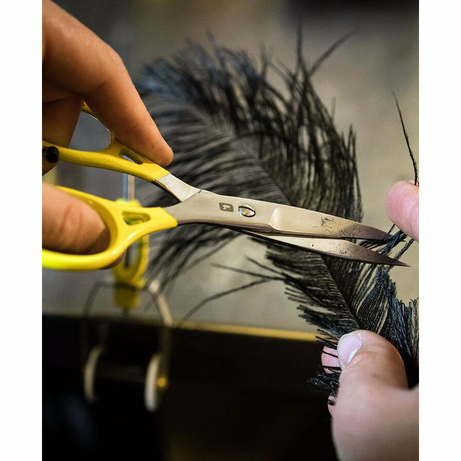 Loon Ergo Prime scissors cutting black feather for fly tying