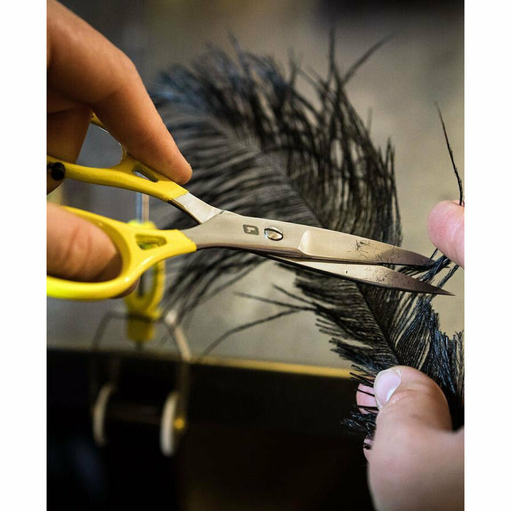 Loon Ergo Prime scissors cutting black feather for fly tying