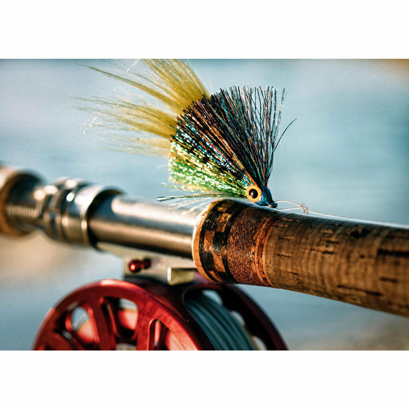 Completed Bluegill light saber fishing lure with segmented green body and pearl eyes