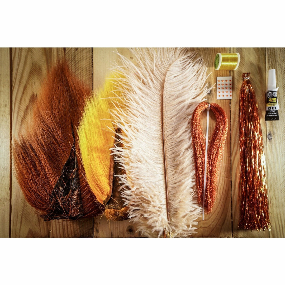 NDCver DIY fly tying kit with tan, yellow bucktail, ostrich plumes, copper flashabou, and thread for tying scud flies