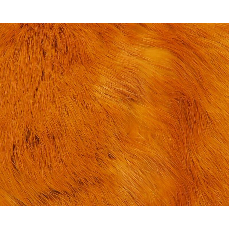 Macro shot of dense vibrant orange rabbit fur texture