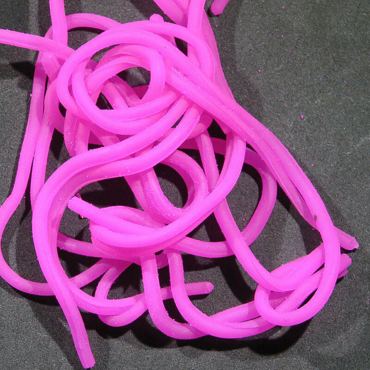 Hot pink worm-like Squirmy Wormies fly tying material detail
