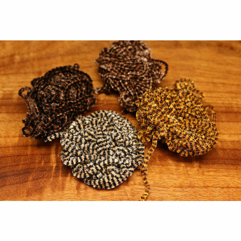 Assorted Stonefly Chenille fly tying materials in brown, black, and gold