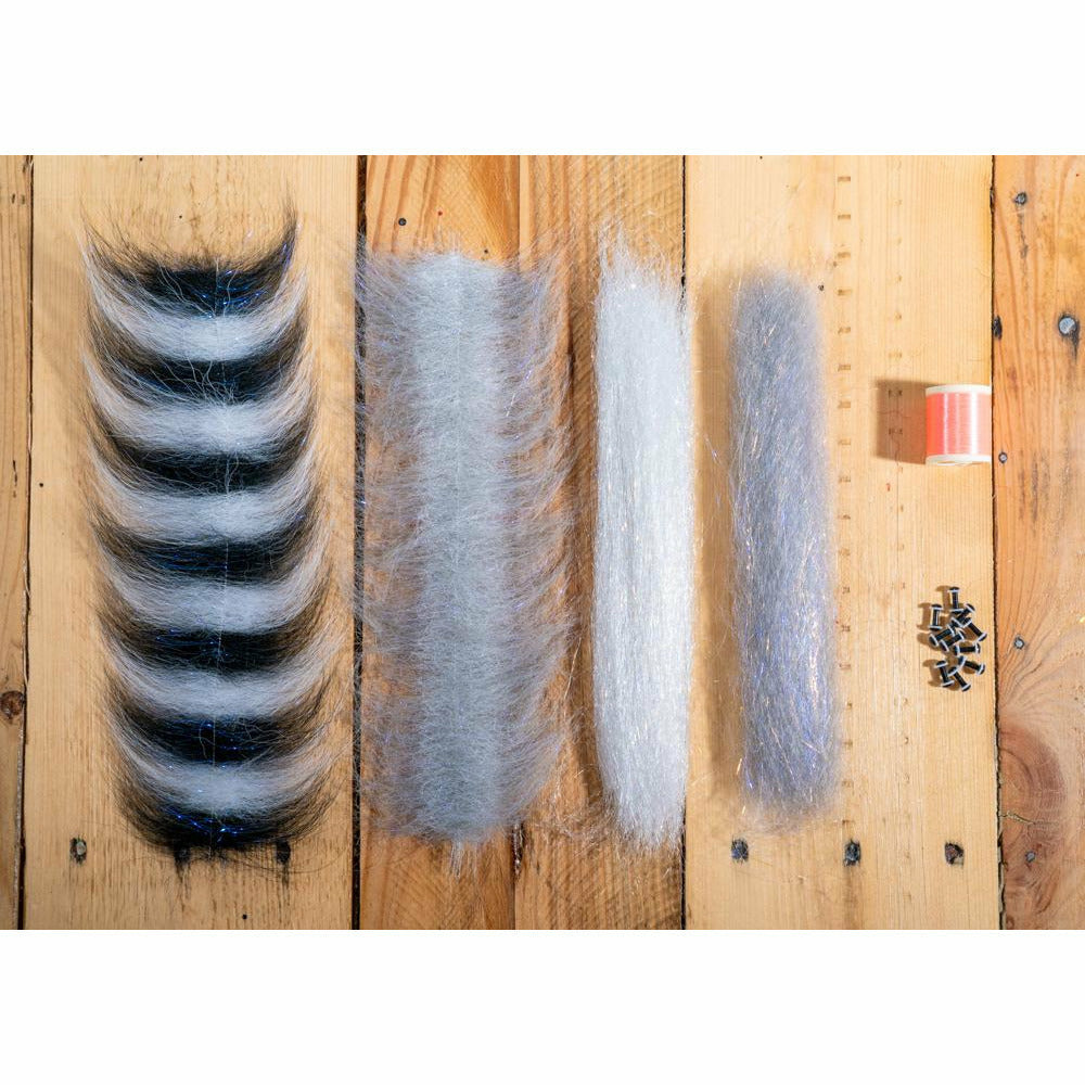 DLP Minnow DIY fly tying kit materials including black and white striped fur, grey dubbing, orange thread, and hook eyes